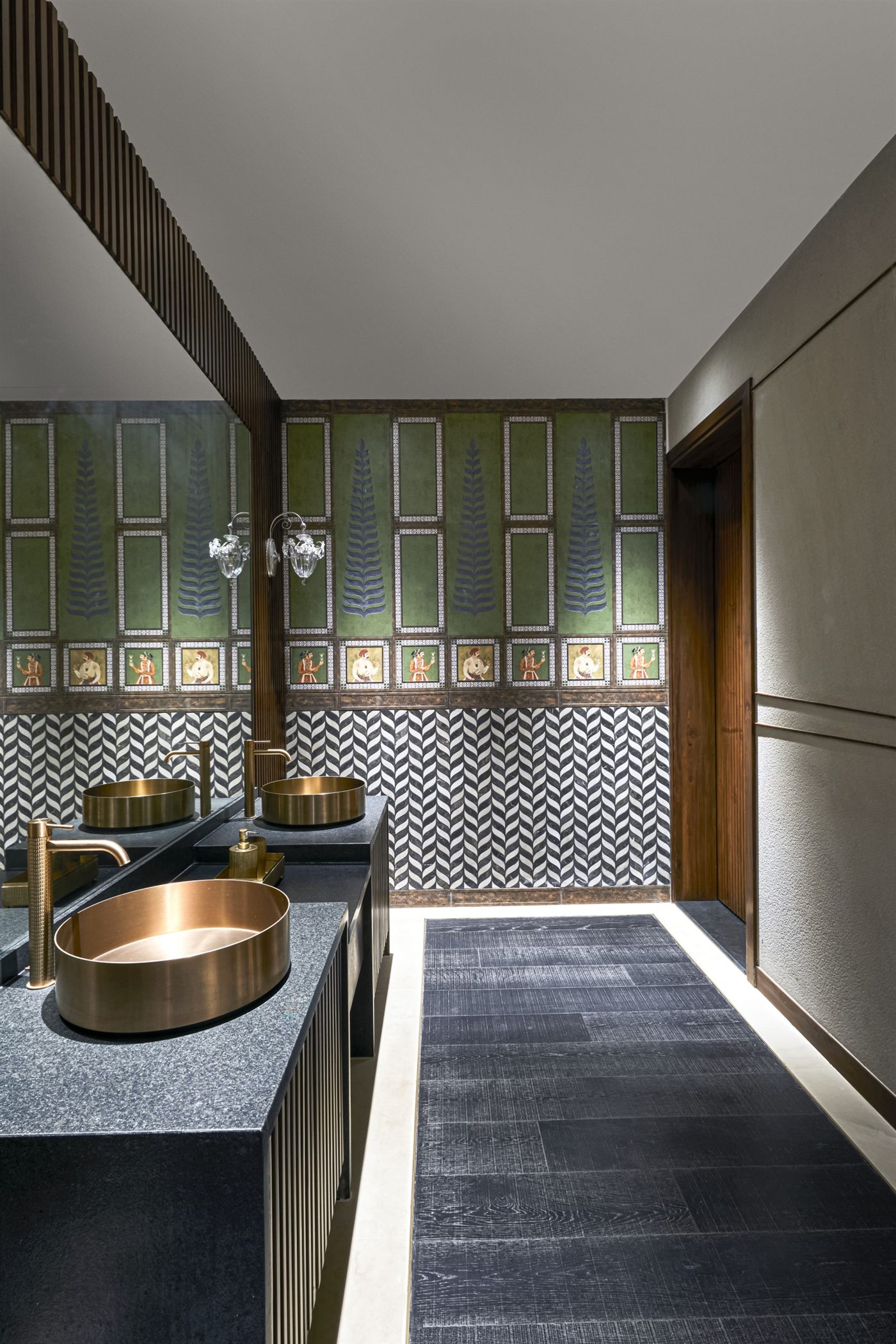 Powder room with brass counter basins and hand-painted panelling
